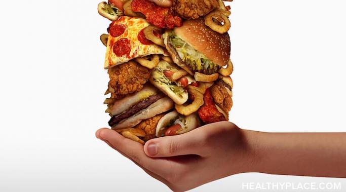 A hand holding a large stack of food